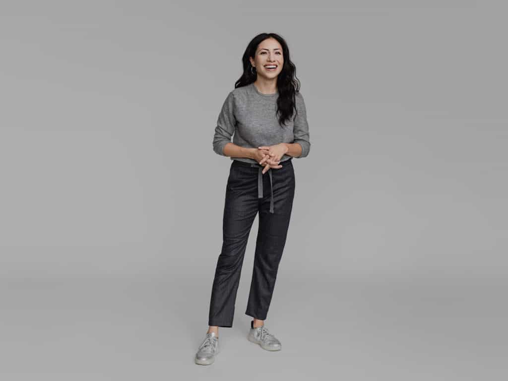 Cassandra Sethi Models A Core Color Sweater With Trousers As An Essential Staple Of A Business Casual Wardrobe