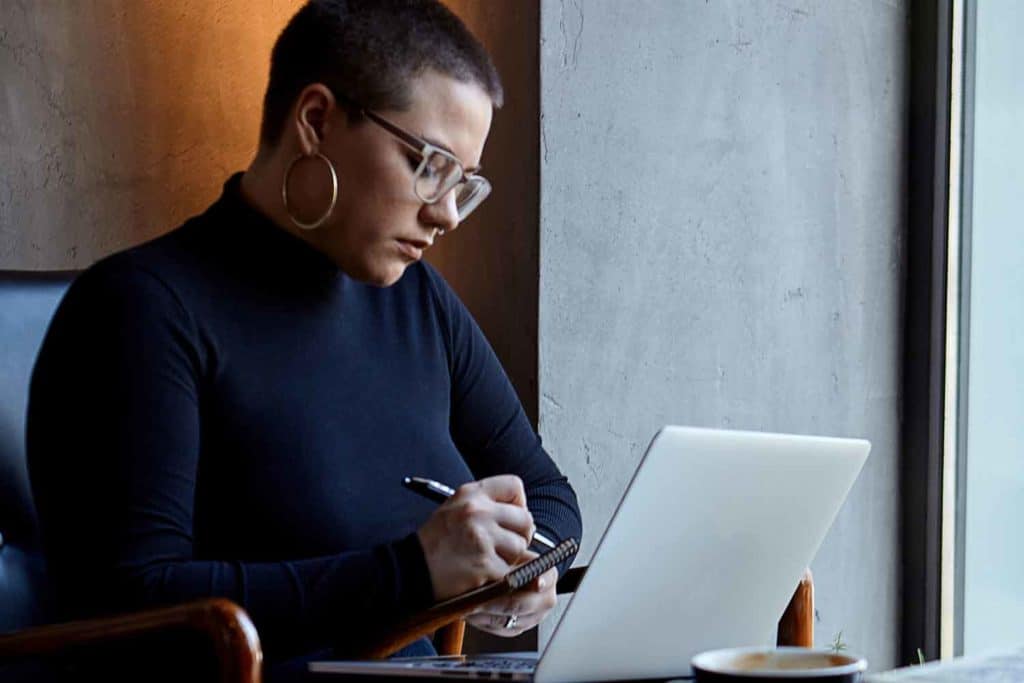 Plus Size Executive Styled In A Turtleneck Sweater Researching Image Consulting On Her Laptop