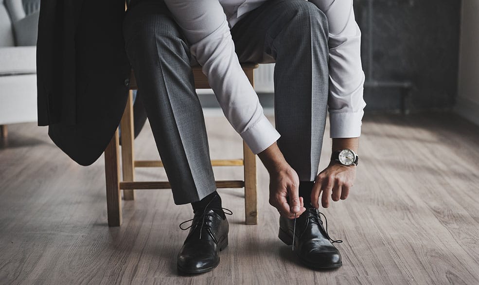 Man Tying His Stylish Shoe After Working With An Online Personal Stylist For Men