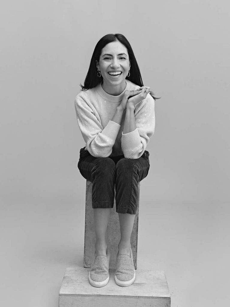 Cassandra Sethi sitting on s stool, black and white photo