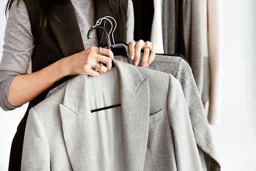 Stylist holding suits 