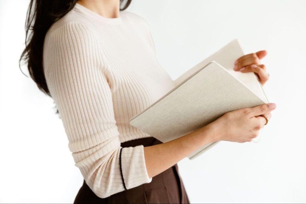 Personal stylist Cassandra Sethi holding a book.